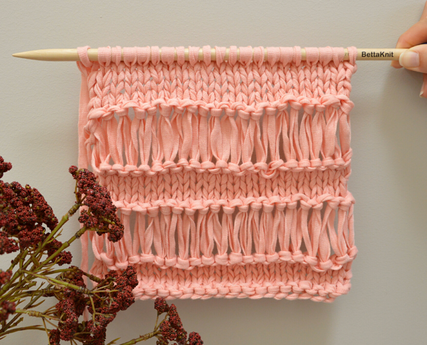 The Drop Stitch (or Elongated Stitch) is an easy knitting stitch you can make by inserting the right needle into each stitch and wrap the yarn around the needle more than once, before dropping the stitch off the left needle. In the following row, each stitch is unraveled to create a "fringe" effect.